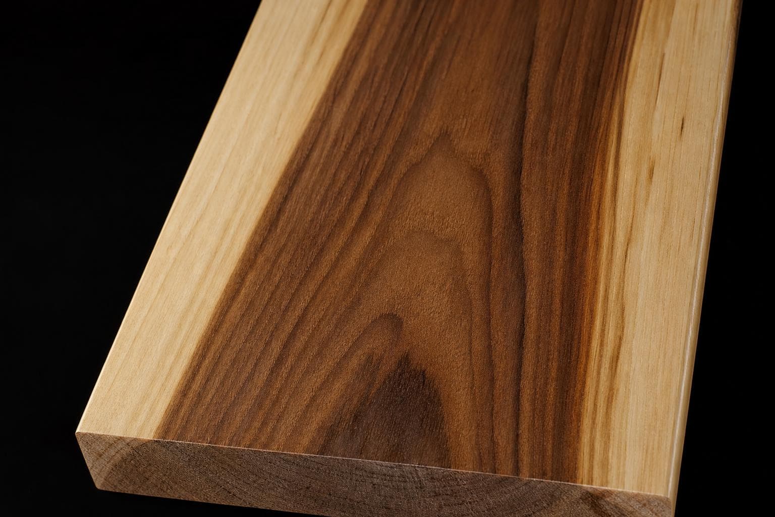Hickory board with dark brown heartwood between pale cream sapwood edges, close-up of the face and end