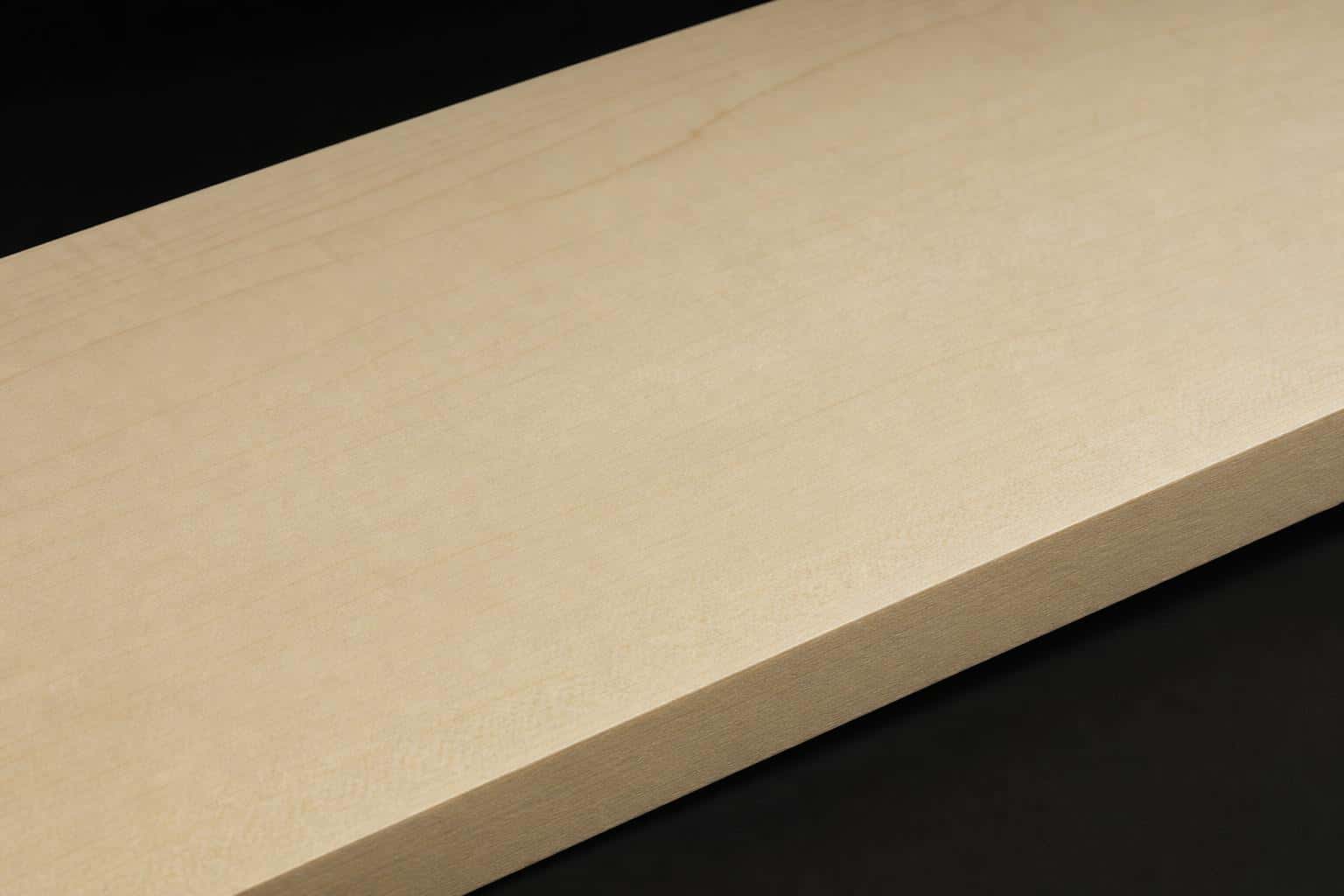 Hard maple board with a pale, creamy face and fine, even grain, close-up of the face and edge