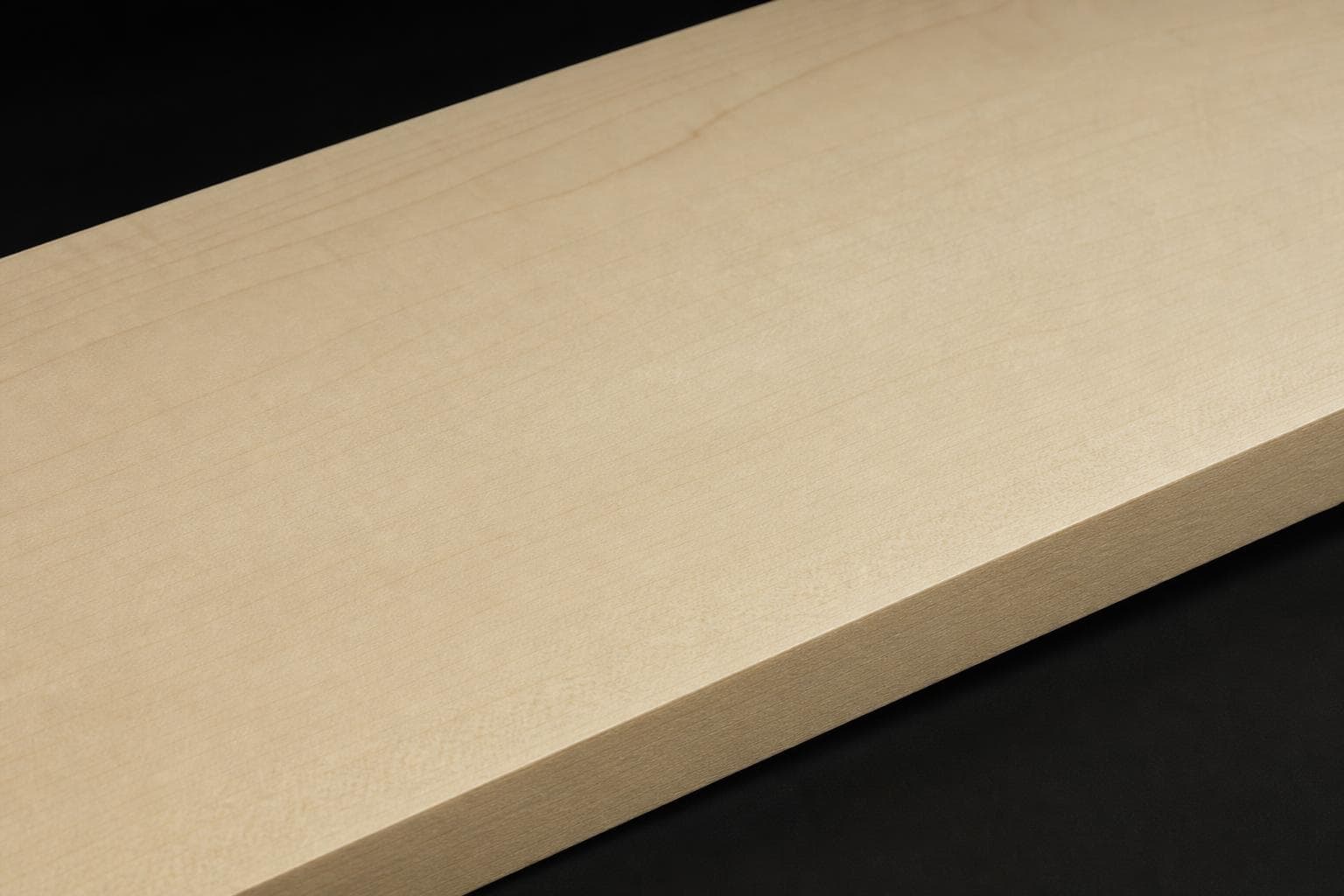 Hard maple board with a pale, creamy face and fine, even grain, close-up of the face and edge