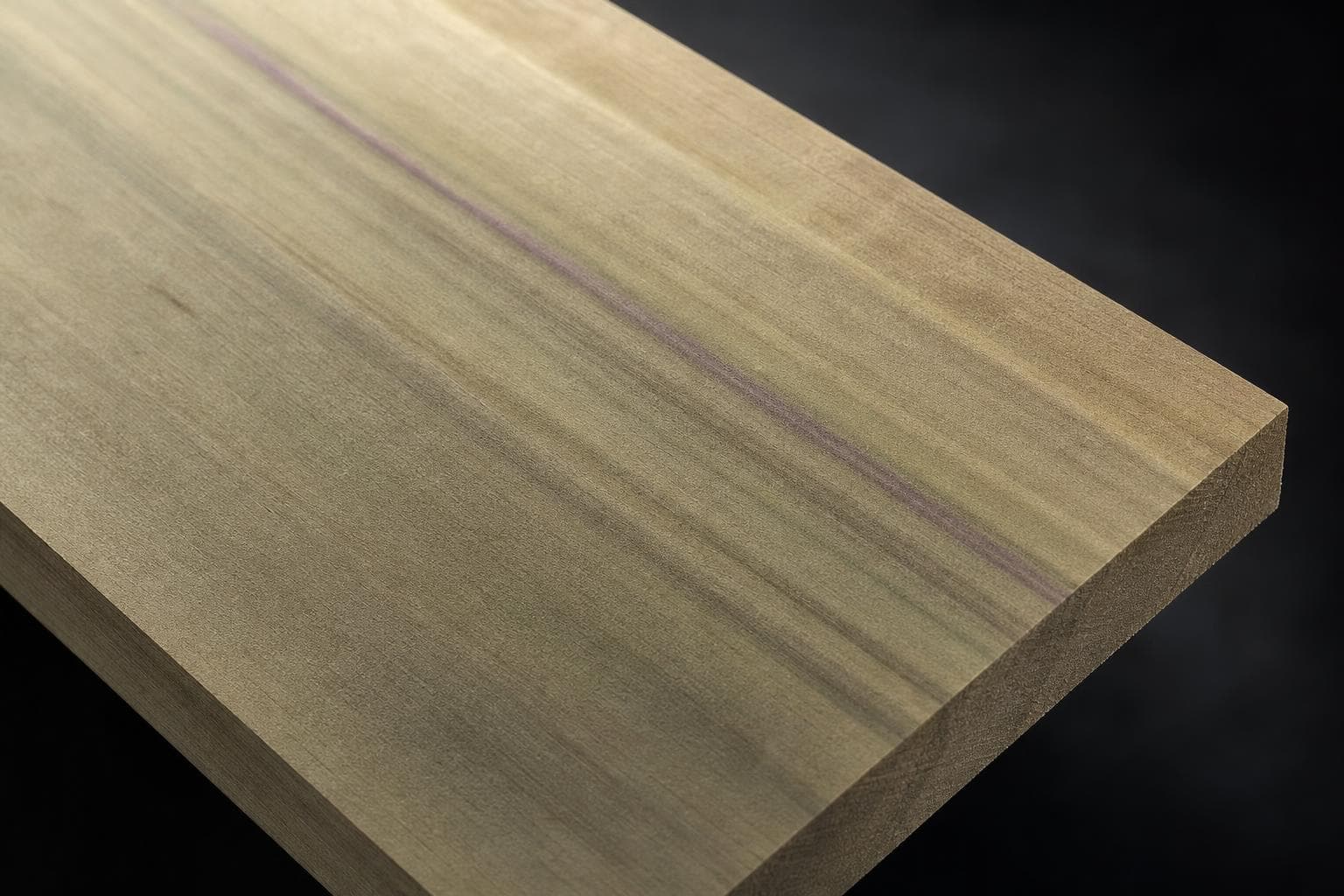 Poplar board with a pale olive-green face and a purple mineral streak, close-up of the face and edge