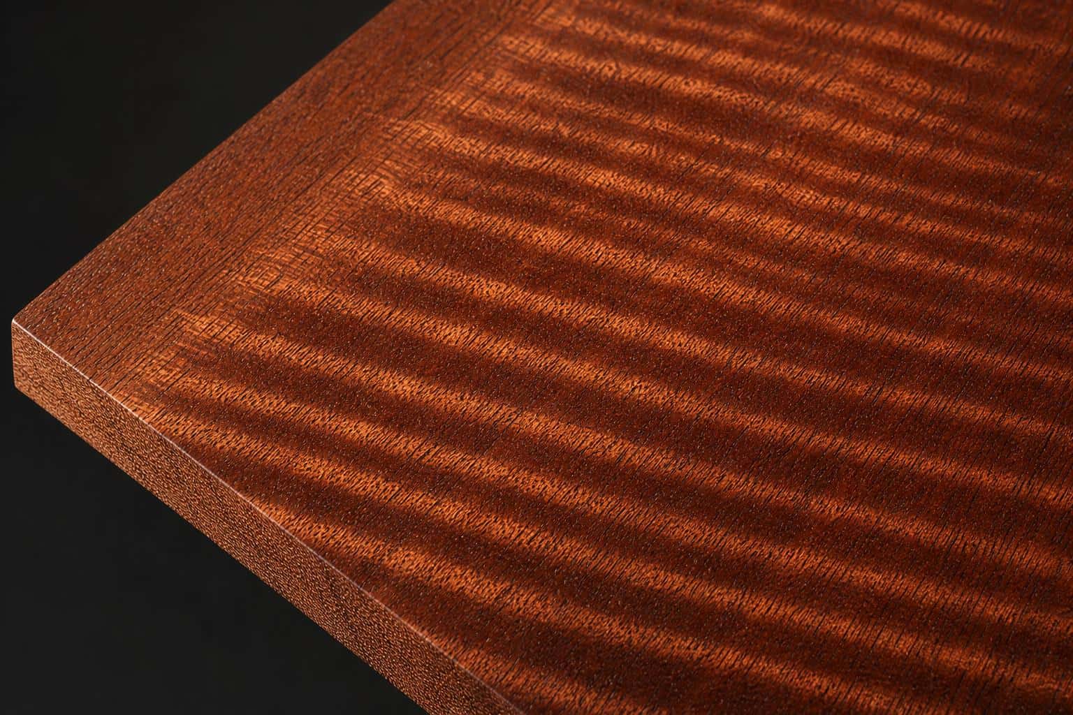Sapele board with a ribbon-striped figure, close-up of the face and edge