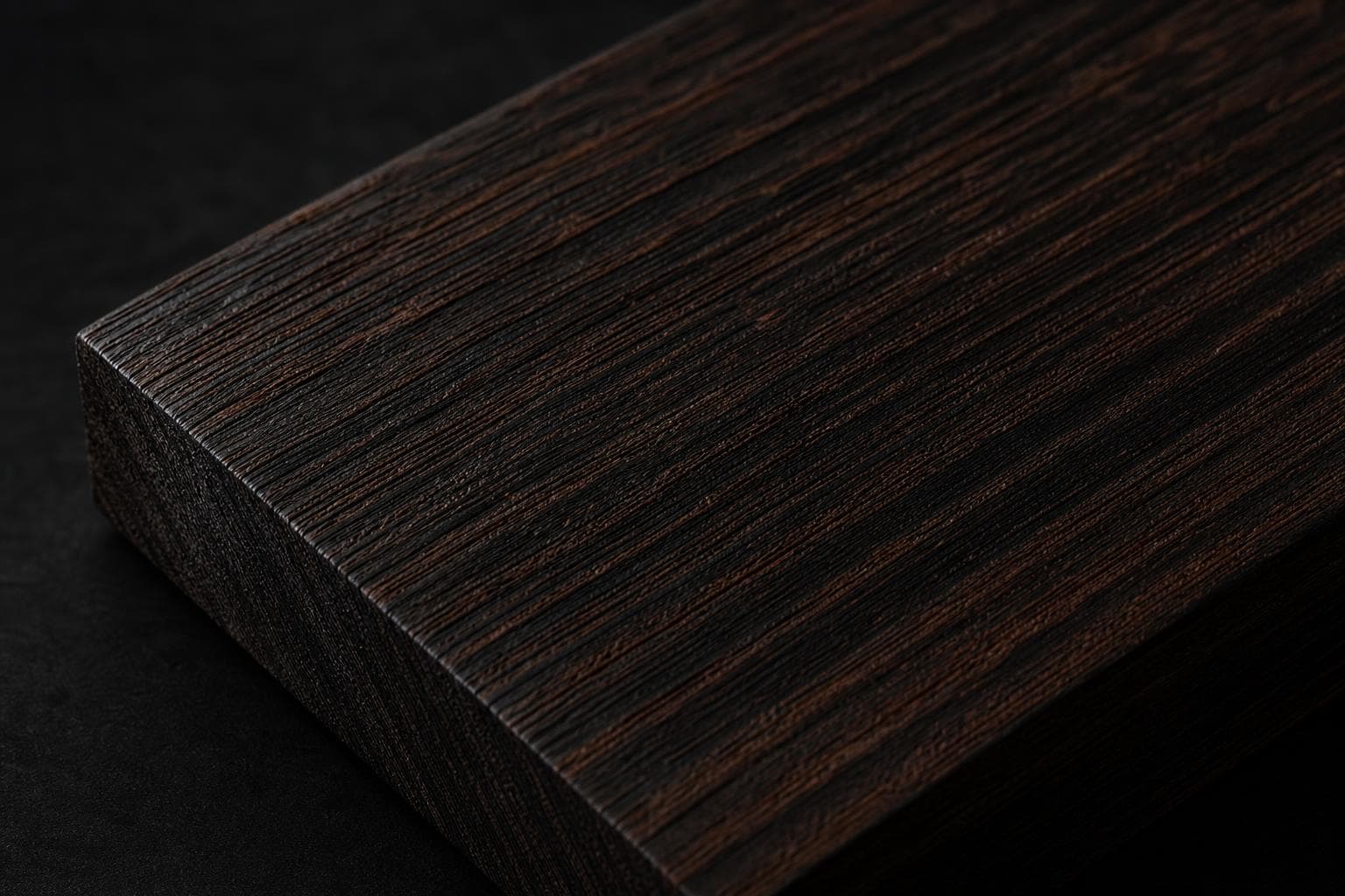 Wenge board, close-up of its dark brown, straight-grained face and edge