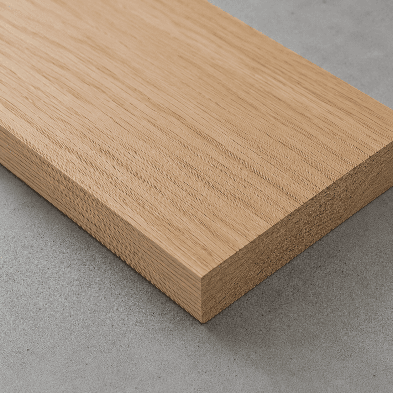 White oak board with straight, tight grain and square-cut edges, close-up of the face and edge
