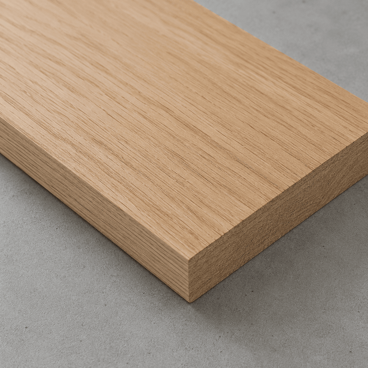 White oak board with straight, tight grain and square-cut edges, close-up of the face and edge